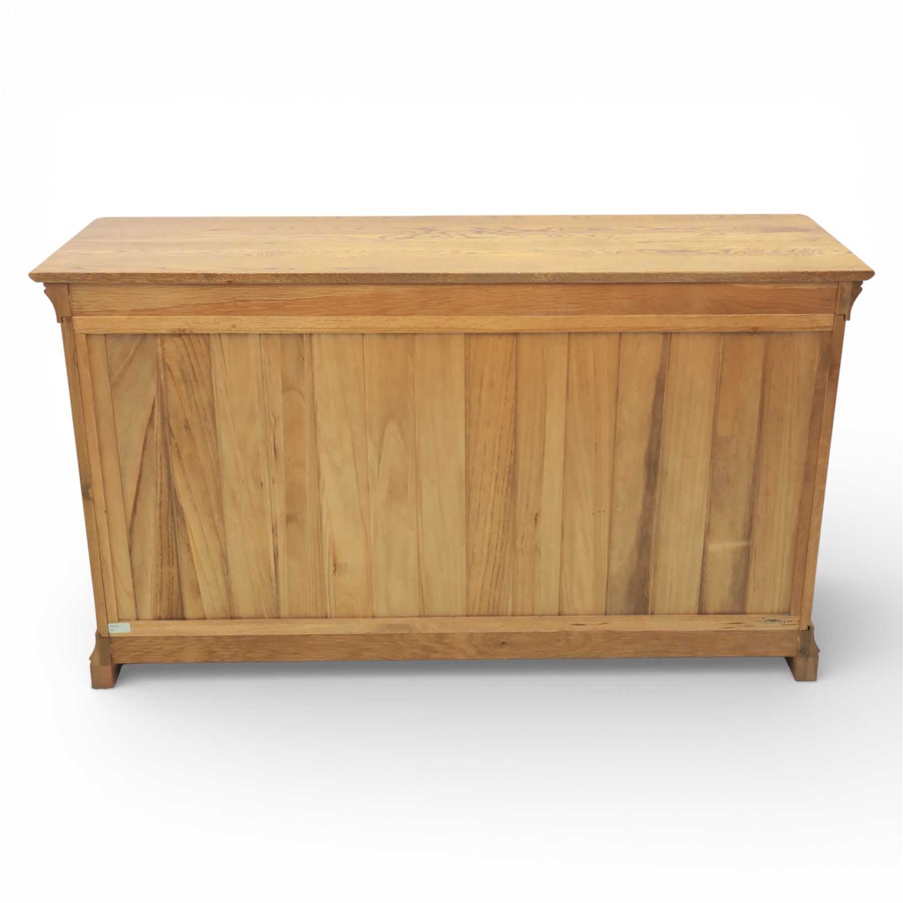 Contemporary oak veneered sideboard, moulded rectangular top above a six drawer arrangement, three over three, each drawer with turned ebonised style knob handle, panelled ends, raised on a shaped plinth base with bracket feet