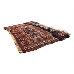 Persian-style wool rug, cream field with floral and geometric motifs, wide floral border (74cm x 142cm); Persian wool rug, beige field with dense floral patterns, narrow floral border (70cm x 144cm); Tribal wool rug, red and navy with diamond motifs (96cm x 60cm); Persian pictorial wool rug, black field with vase, birds, and floral border (70cm x 73cm)