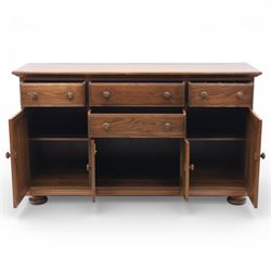 Ercol - elm dresser sideboard, fitted with four drawers and four cupboards with carved detail, drawer featuring cutlery slide