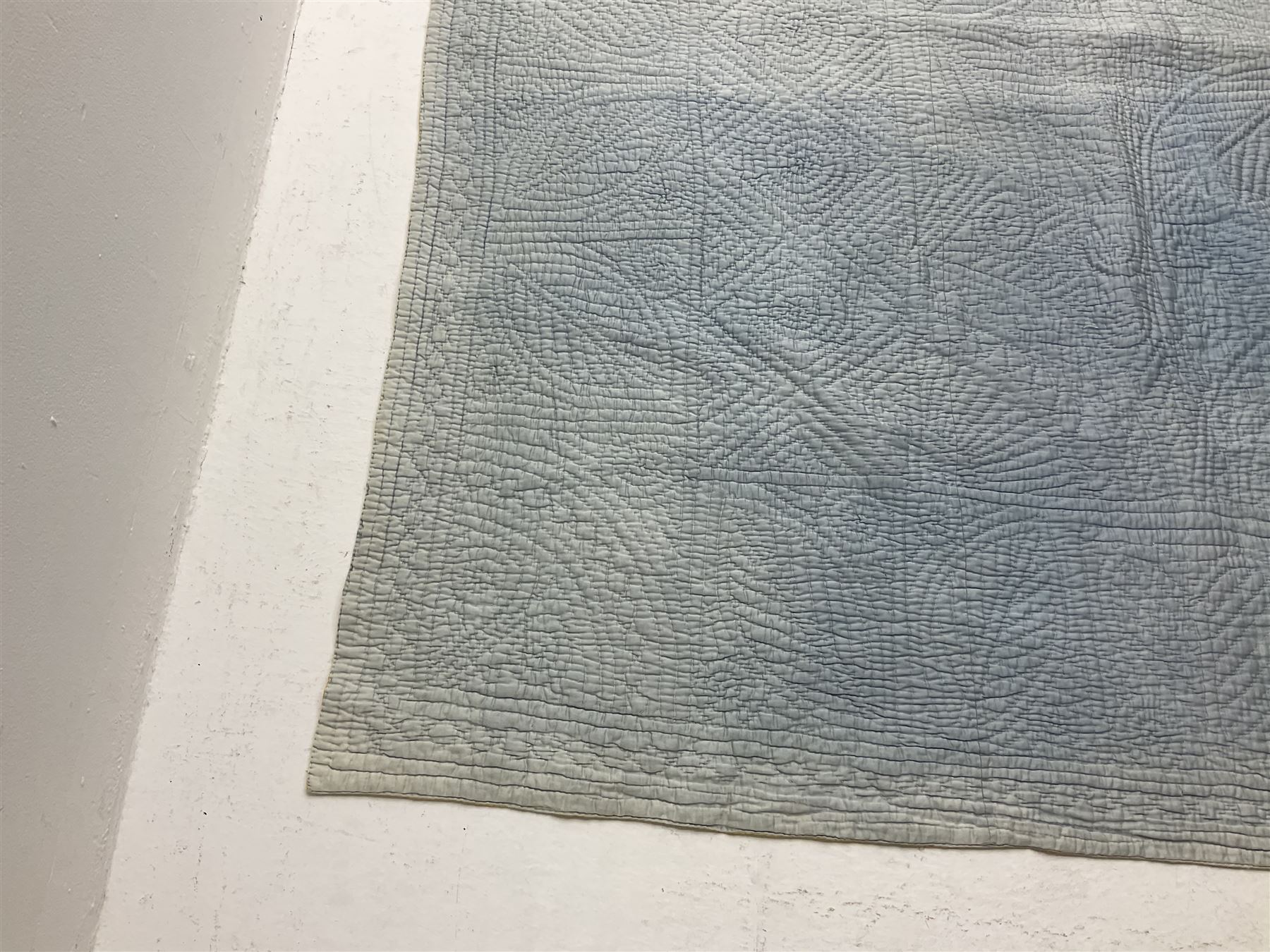 Early 20th century Welsh whole cloth sky blue quilt, in traditional quilting patterns, supported on yellow coloured backing, 174cm x 204cm