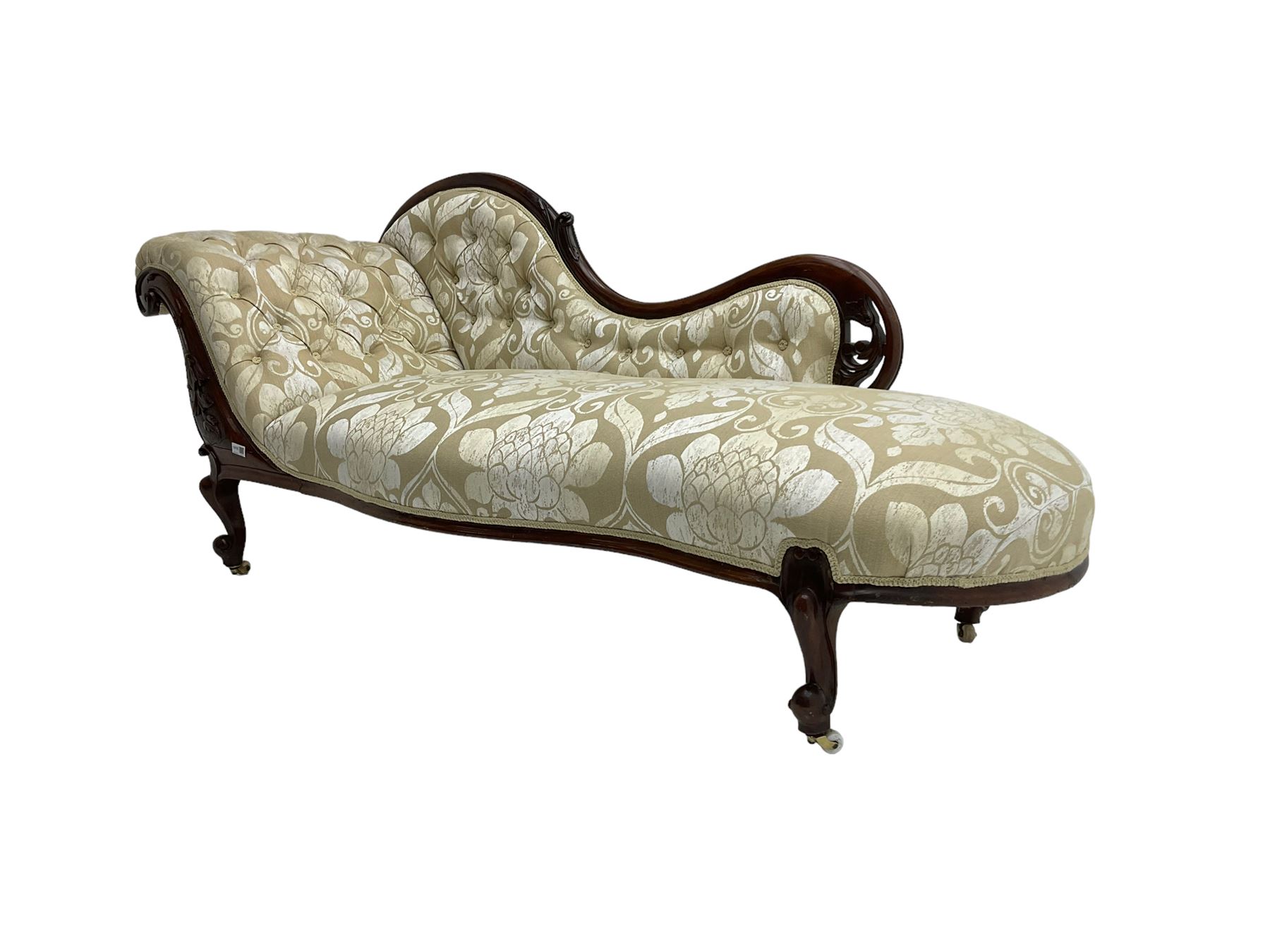 Victorian mahogany chaise longue, scrolled back with pierced and floral carved decoration, champagne foliate pattern fabric, cabriole feet with brass and ceramic castors