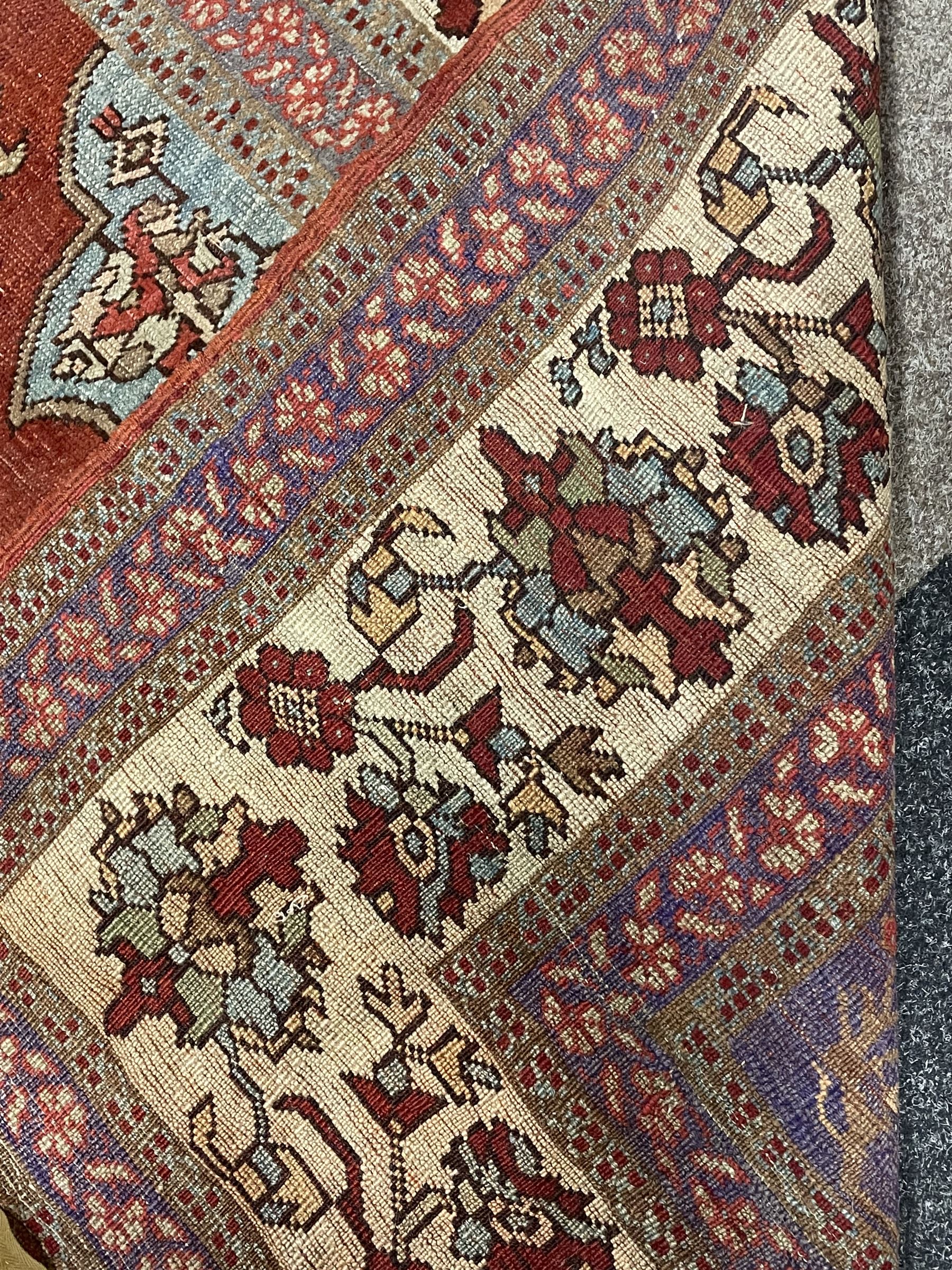 Persian red ground prayer rug, decorated with stylised flowers (201cm x 143cm), and a small Persian design triple medallion rug (142cm x 68cm)