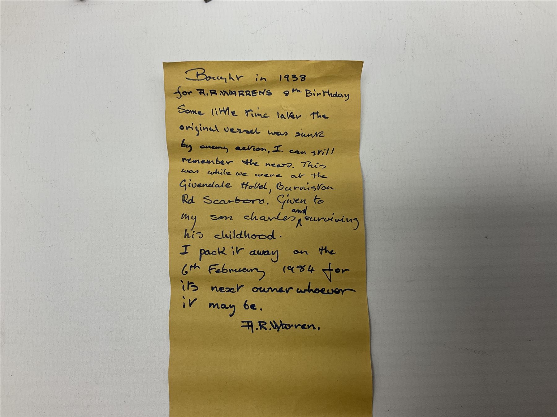 Pre-war Sutcliffe Grenville tinplate clockwork Battleship, with black and grey hull, grey deck and upper decks, propeller and rudder, length 32cm; with manuscript biographical details and two keys, unboxed