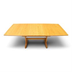 Ercol - 'Windsor' ash medium extending dining table, with stowed fold over leaf extending to 200cm, shaped supports with roundel aperture, united by a stretcher