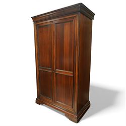 Willis & Gambier - French cherry wood double wardrobe, moulded cornice above two panelled doors opening to a hanging interior with rail and shelf, raised on bracket feet
