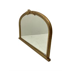 Gilt framed overmantle mirror, the arched plate within framed with repeating beaded decoration and oak leaf pediment with acorn