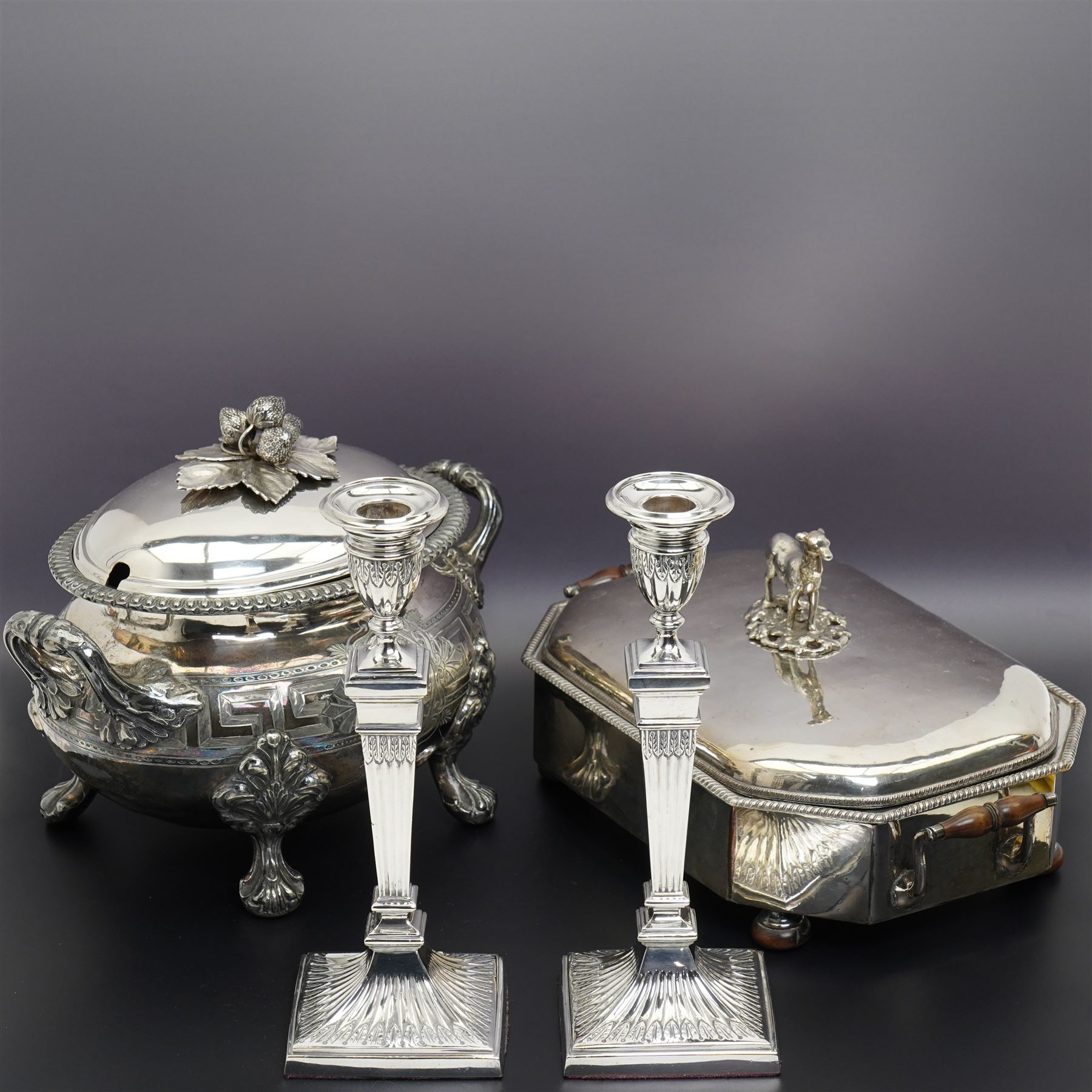 Pair of Georgian design plated candlesticks on square bases H26cm, plated hot water dish, the cover with deer lift and a plated two handled tureen with associated cover