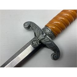 Late WW2 German Army Officers dress dagger, with unmarked 25cm double edged steel blade, orange celluloid grip, pommel and ferrule with oakleaves relief and cross guard with eagle; in original beaded scabbard with two hanging rings L39.5cm overall