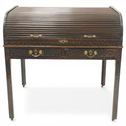 Late 18th century George III mahogany Chippendale design cylindrical roll-top desk carved profusely with geometric and foliate blind-fretwork throughout, the tambour-roll top opening to reveal pigeon holes over an inset red leather writing surface, fitted with two frieze drawers below, raised on square supports with inner chamfer terminating to brass castors, circa 1780s