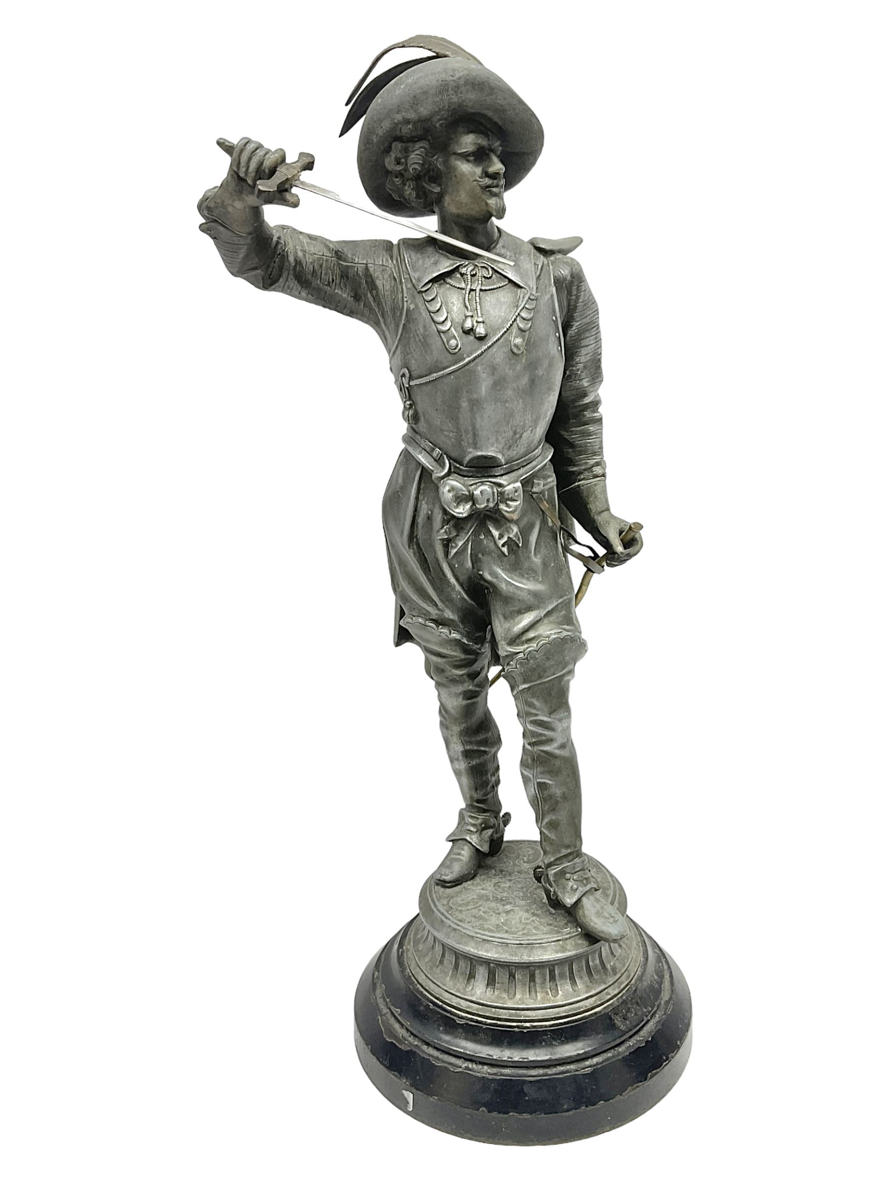 Spelter figure modeled as Cavalier with a raised sword, upon a circular base, H52cm