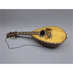  Late 19th/early 20th century Italian lute back mandolin with segmented rosewood back and spruce top, eight brass and bone pegs and four strings, bears label for Giuseppi Puglisi Catania, L61cm, in carrying case with detached top  