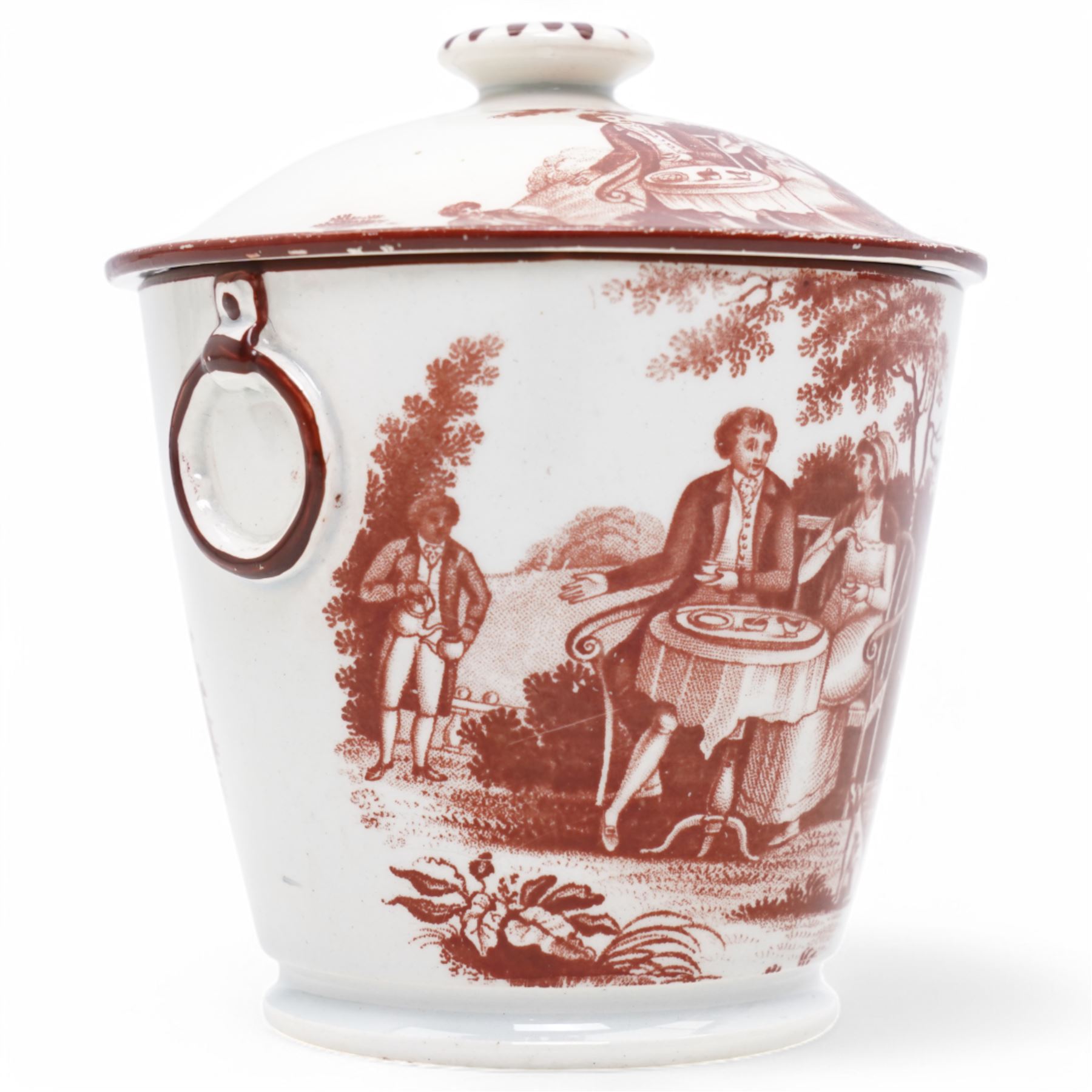 Early 19th century cream pail and cover printed in terracotta with figures sitting in a garden taking tea and with faux loop handles, with old label to the base 'Shorthose & Co. Staffordshire' H9cm