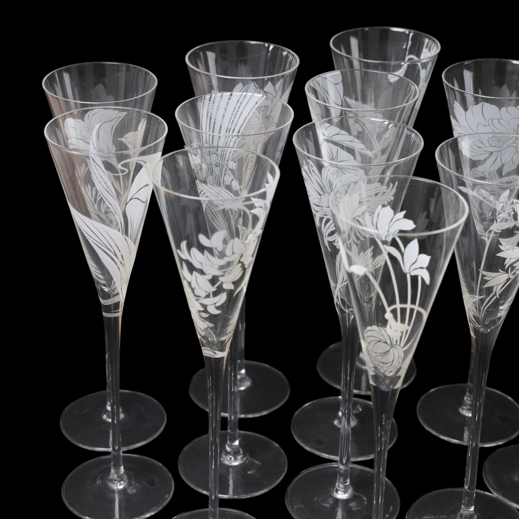 Twelve Crystal champagne glasses Les Fleurs, issued by the Franklin Mint in collaboration with Perrier Jouet, each glass is etched with a different flower, all boxed 