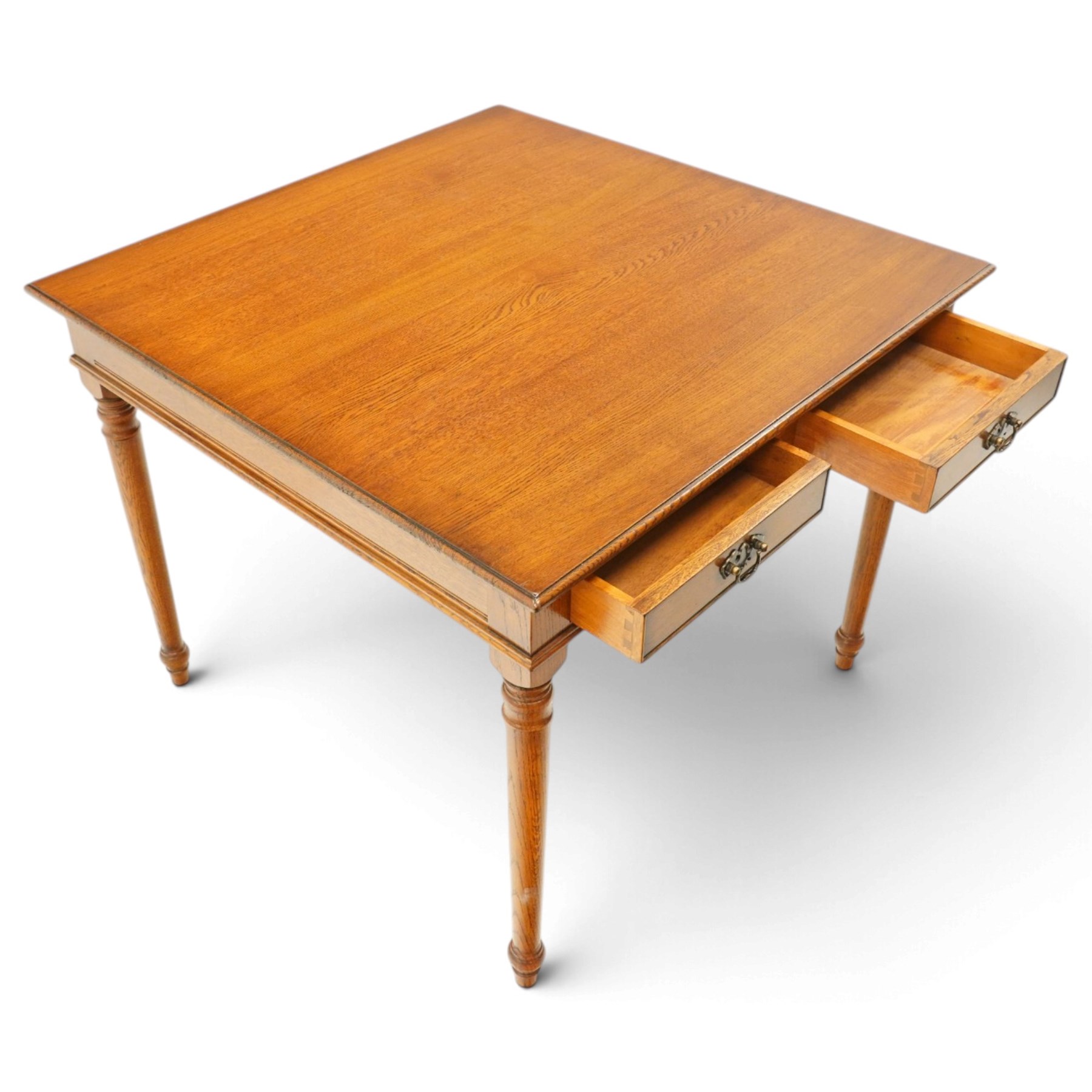 Georgian design honey-oak breakfast table of square form, the moulded edge fitted with two cock-beaded drawers, raised on turned and tapering supports