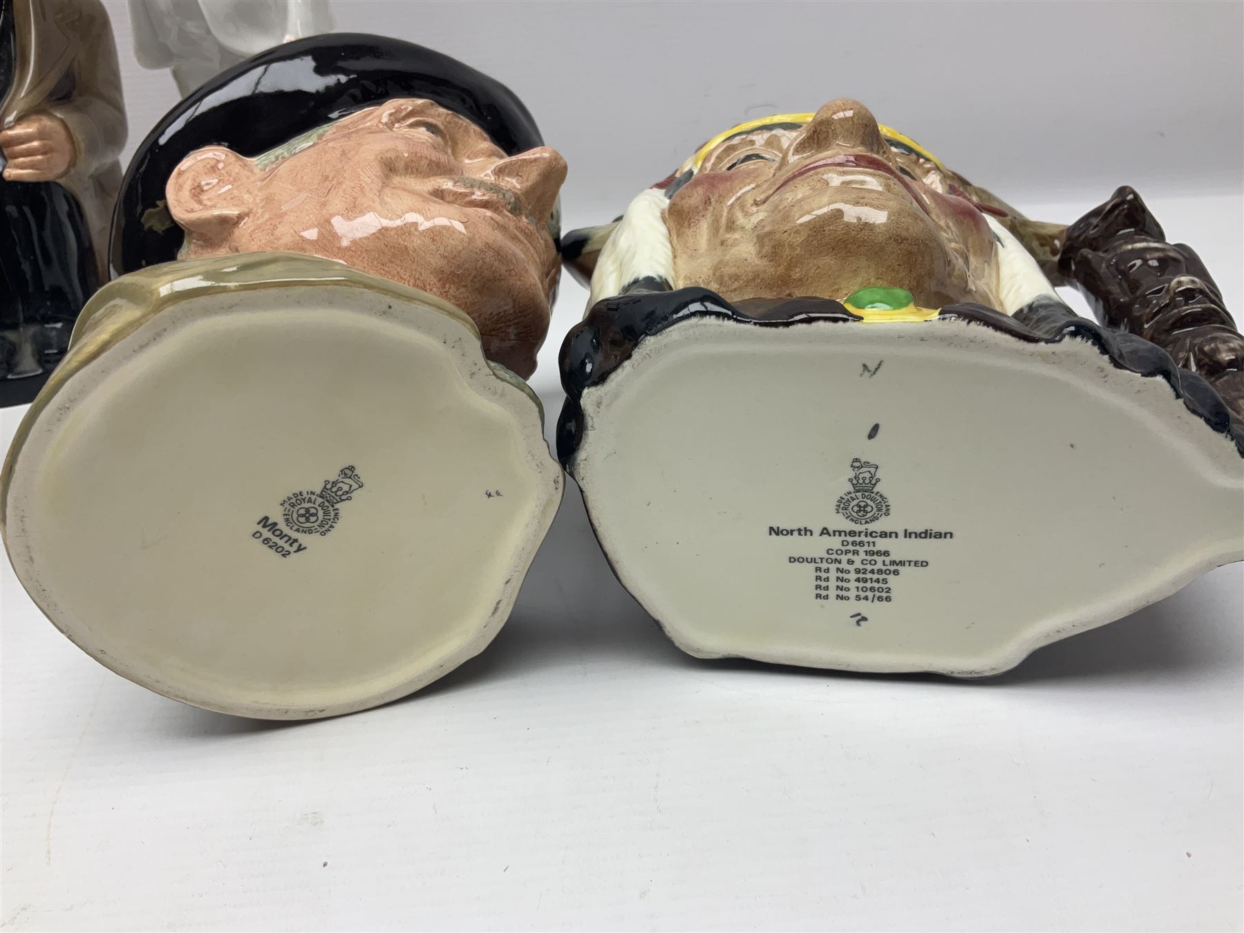 Royal Doulton Sir Winston Churchill figure HN3057, together with Winston Churchill toby jug, and three character jugs 