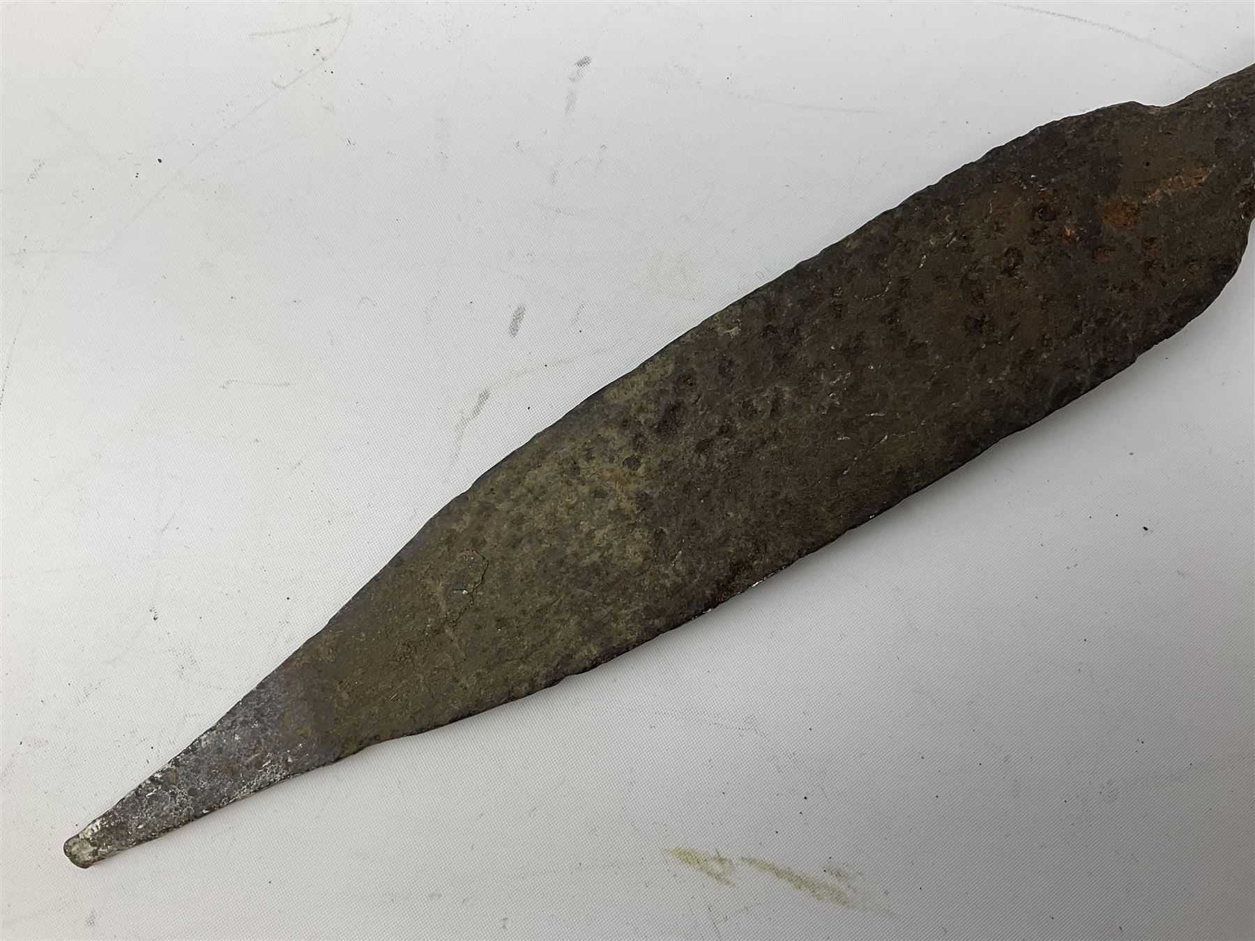 Patinated 'bronze' fantasy dagger, the 26cm blade, hilt and scabbard cast with dragons L50cm overall; hand forged iron spearhead L29.5cm; and a stiletto blade (3)