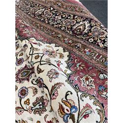 Finely knotted Persian Qom silk rug, overall pink ground with ivory field, the field with central cusped medallion profusely decorated with interlacing foliate and stylised flower heads, multiple band boarder, the main band decorated with a series of stylised motifs and trailing foliage, the outer guard with signature panel 