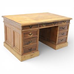 Late 19th century Victorian pine twin pedestal desk, rectangular plank top above an arrang...