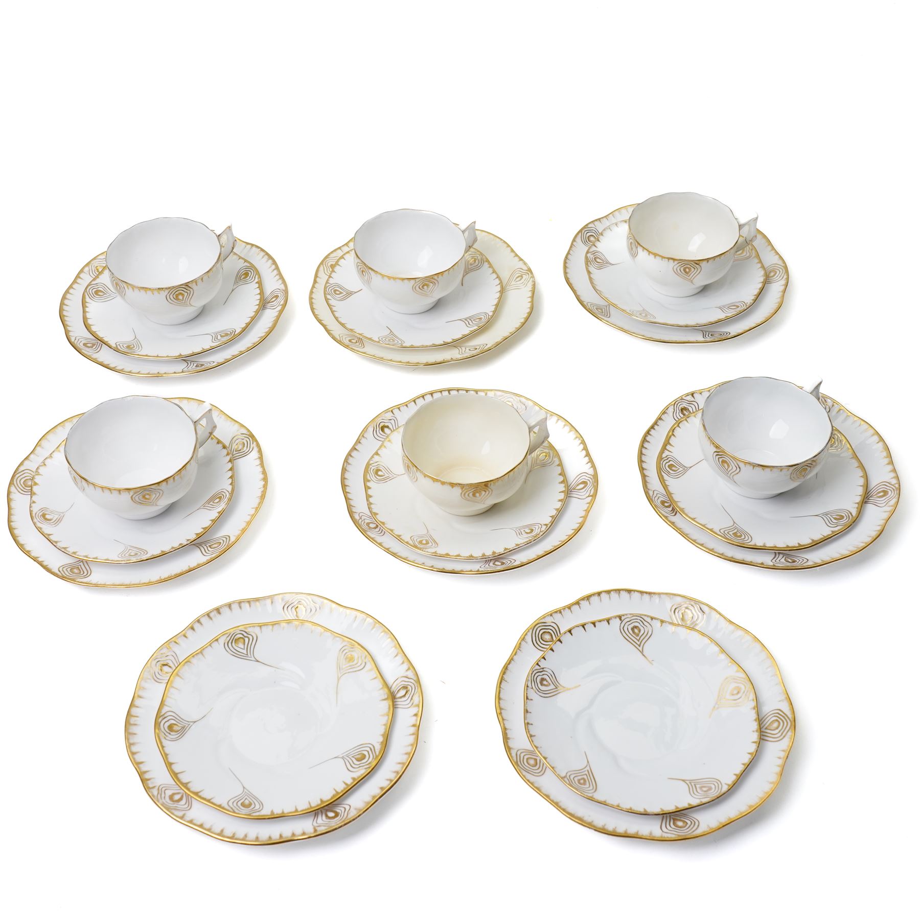 Early 20th century Sarreguemines tea wares, decorated with peacock feathers in gilt, comprising six teacups, eight saucers and eight side plates