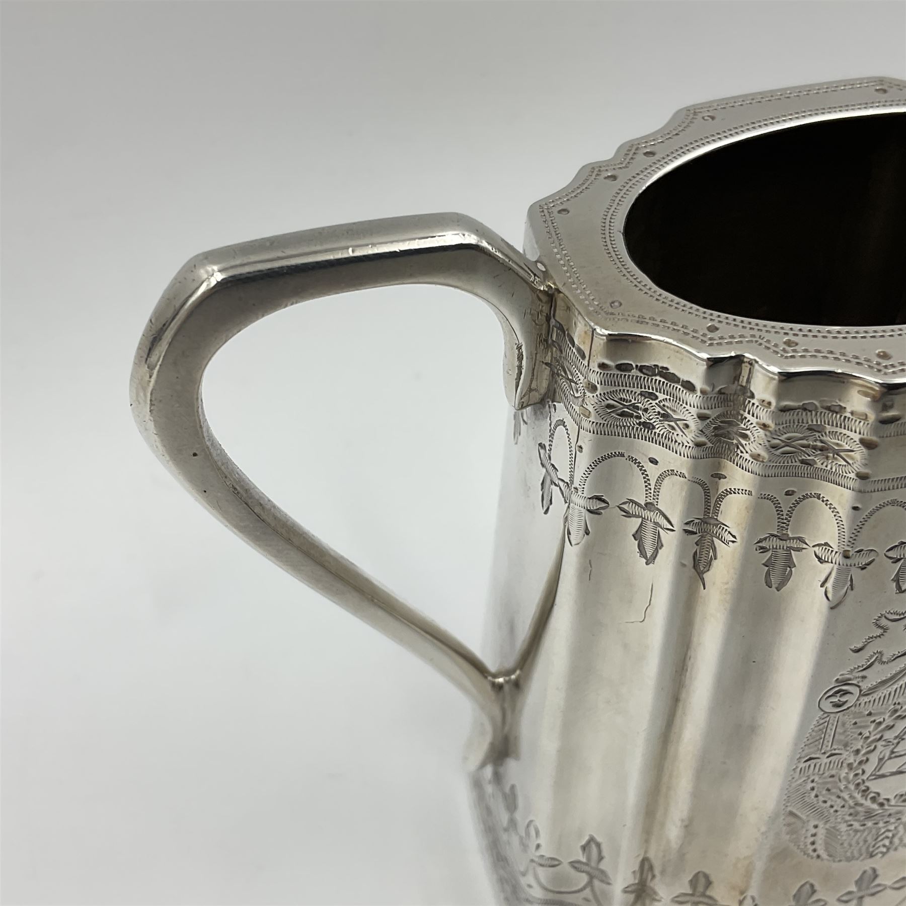 Victorian three-piece silver tea service, comprising teapot, twin handled open sucrier and milk jug, of oval form with shaped rim and C handles, each engraved with crests and bands of strapwork decoration, the milk jug and sucrier with gilt interiors, hallmarked Josiah Williams & Co, Exeter 1881, the teapot with ivory insulators and finial, all contained with a tooled leather, blue silk and velvet lined fitted case, retailed by West & Sun, Dublin 
This item has been registered for sale under Section 10 of the APHA Ivory Act