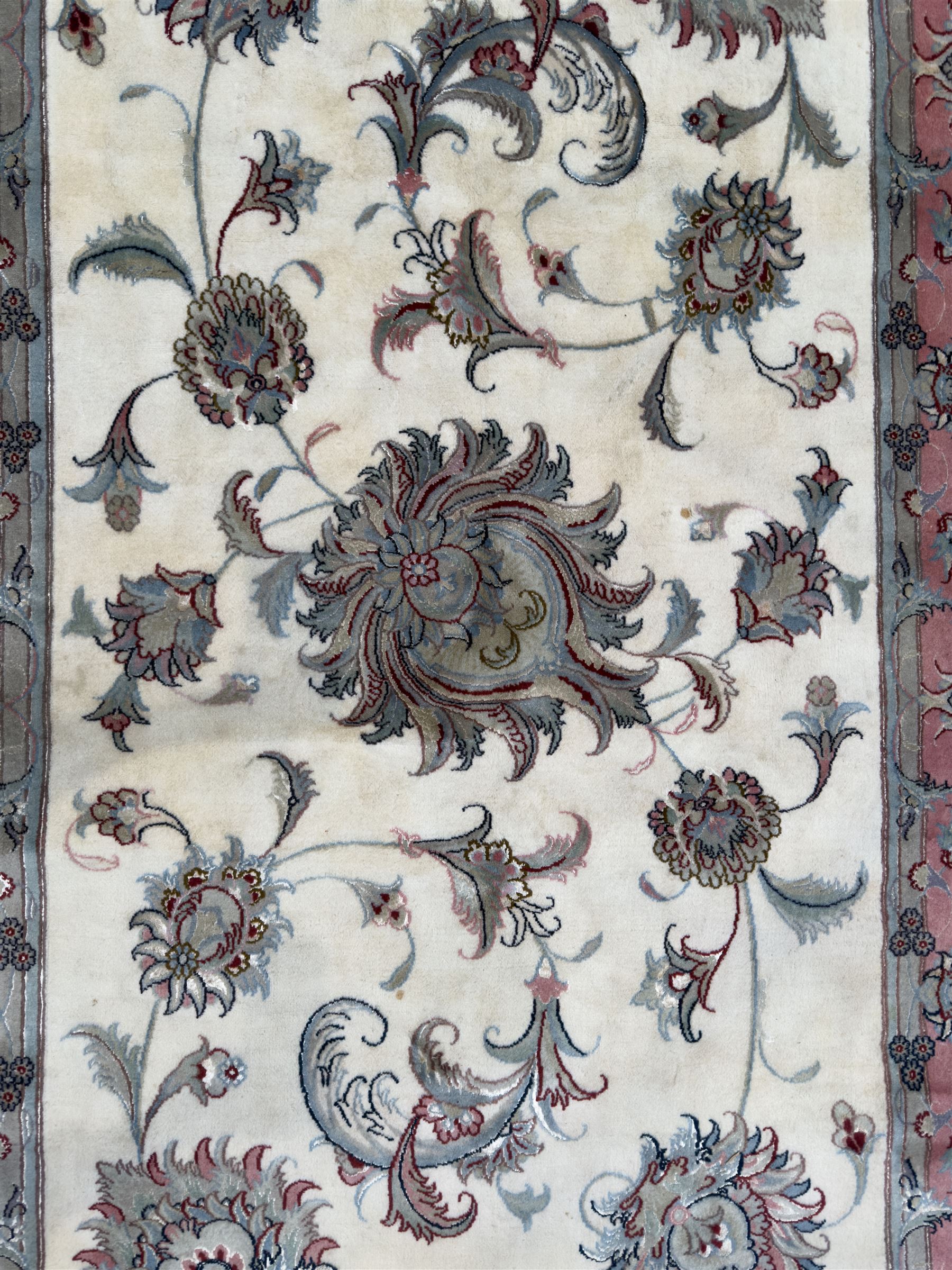 North East Persian Kashmar hand-knotted rug, ivory field with an all-over design of linked floral medallions and scrolling vines with a central circular medallion enclosed by multiple borders and a main broad madder field with palmettes and arabesques, 248cm x 145cm