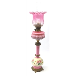  19th century French pink opaque glass oil lamp with cranberry glass shade, cream glass knop painted with trailing foliage and gilt metal mounts, H74cm excluding funnel   