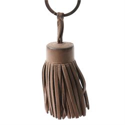 Hermès - leather tassel keyring or bag charm, taupe leather with palladium-tone split ring, with box