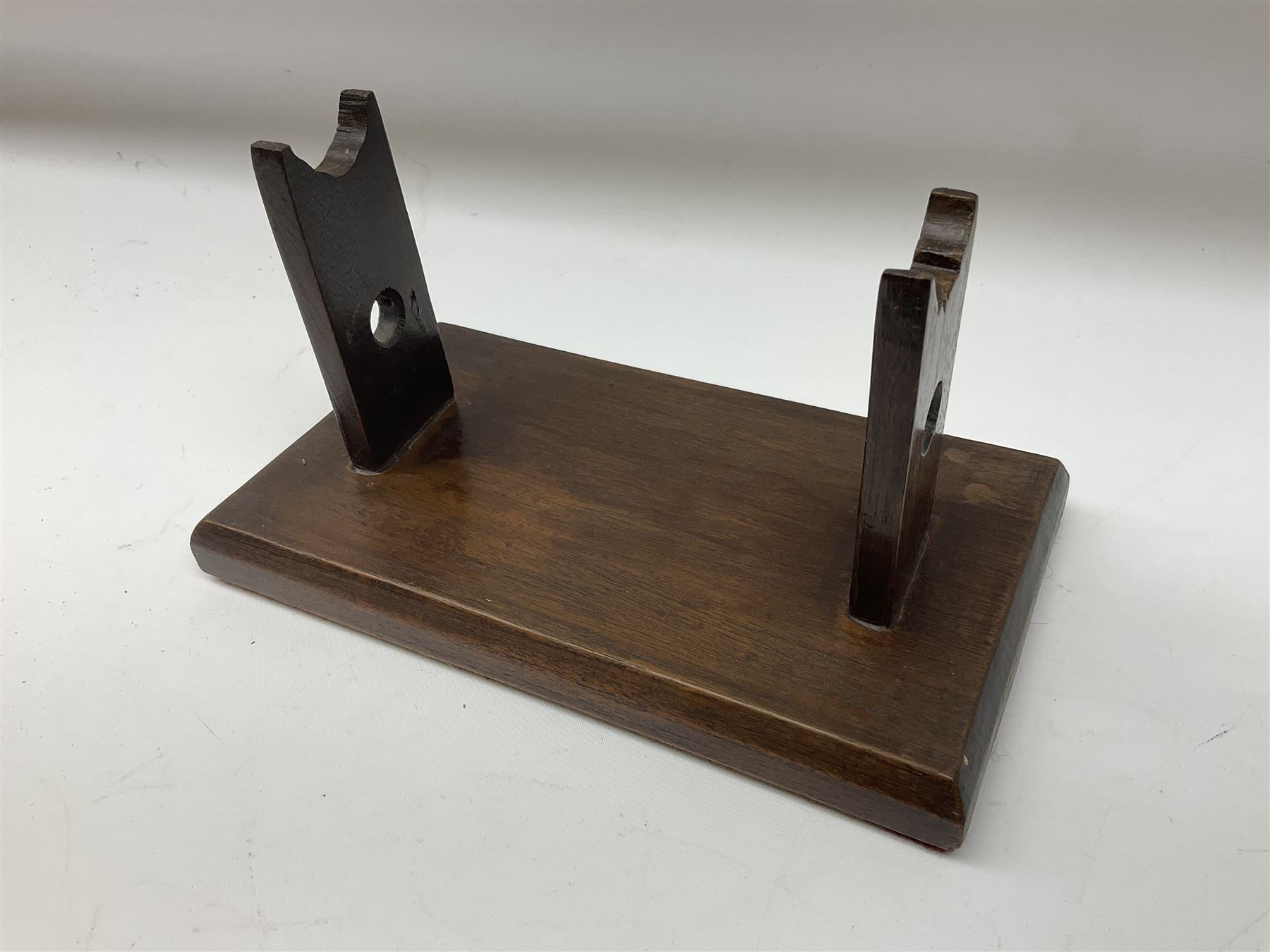 Early 19th century flintlock 16-bore overcoat/duelling pistol by William Bond Lombard Street London, the 23cm octagonal brown stub twist damascus barrel with small foresight, two barrel pins and ram rod under, inscribed Lombard Street London to the top and W. Bond to the action, full walnut stock with lightly engraved steel furniture, pineapple finial and escutcheon, half cock facility L39cm; loose mounted on later mahogany display stand with trade label