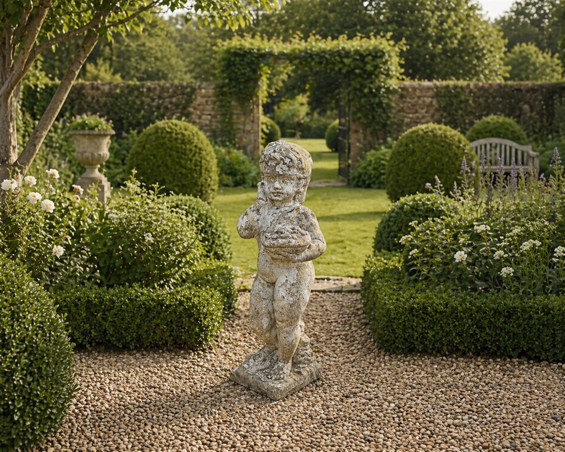 Early composition stone figure of a boy with grape basket, original flakey white paint