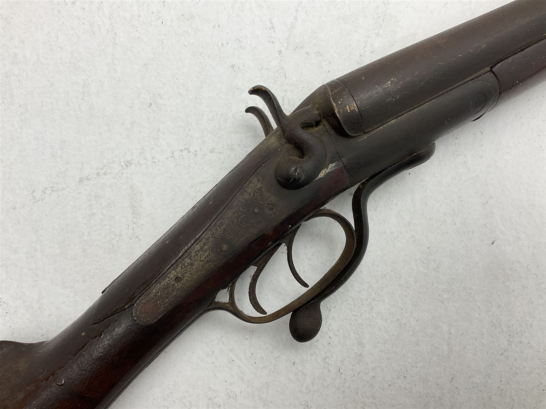WW1 Lee Enfield SMLE .303 bolt action rifle with 63.5cm barrel and magazine; No.20934; L112cm overall; home deactivated by welding down bolt and end of barrel so requires re-deactivation to modern standards; and 19th century 12-bore double barrel hammer shotgun with 65cm cut-down barrels, non-rebounding hammers and under-lever opening, the lock-plate indistinctly inscribed G.T. Bartrant(?) L75cm overall; home deactivated by welding both barrels closed at breech so requires re-deactivation to modern standards (2) RFD ONLY 