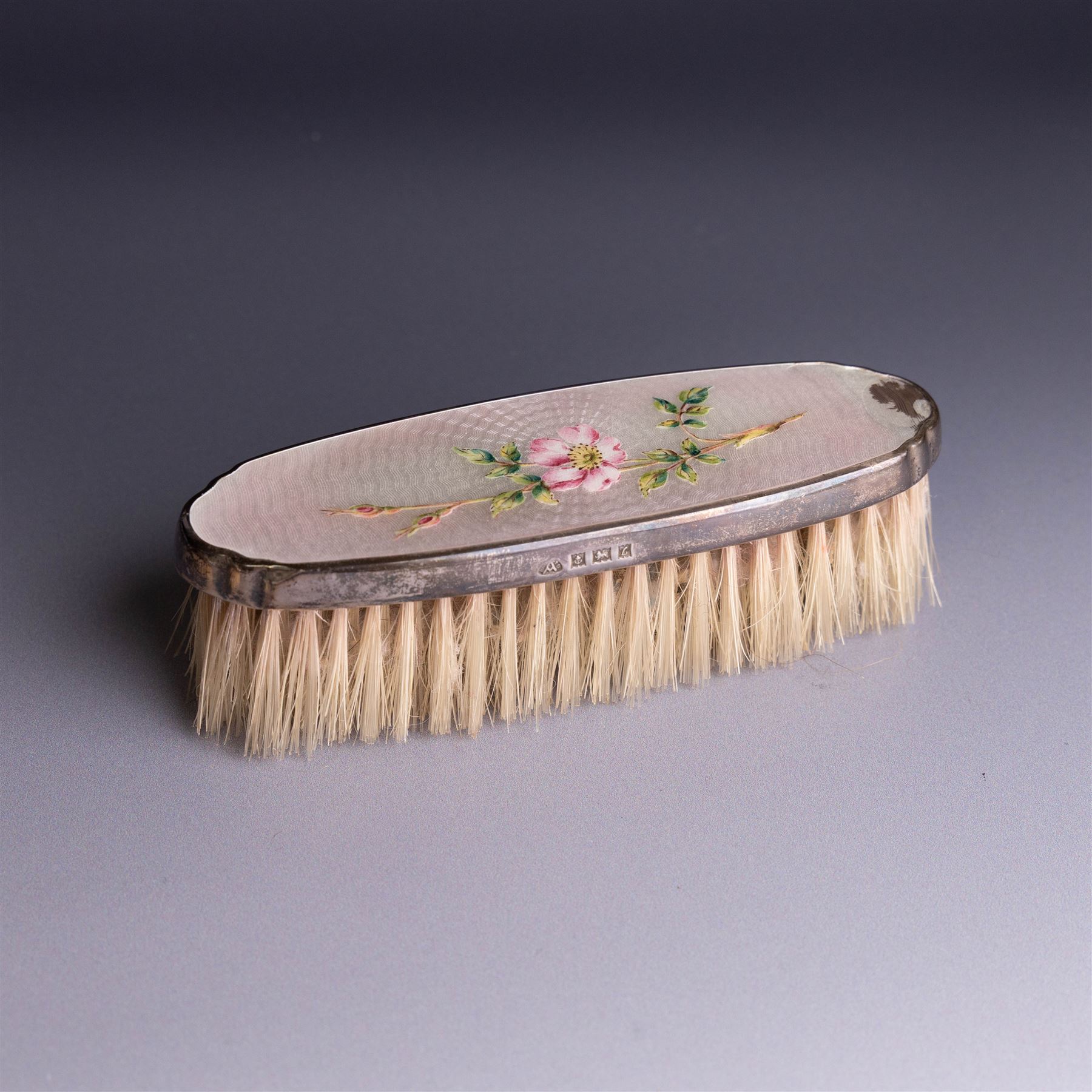 Mid 20th century silver mounted hairbrush and clothes brush, with guilloche enamel floral decoration, hallmarked Adie Brothers Ltd, Birmingham 1960, together with an silver mounted glass scent bottle, the glass with etched floral decoration and engine turned cover, hallmarked 