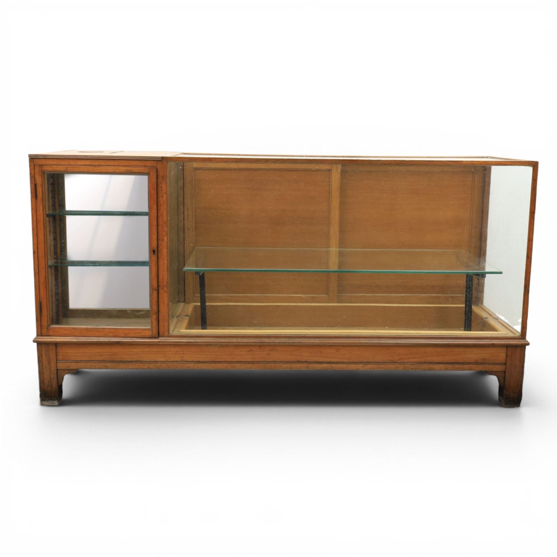 Early 20th century oak framed and glazed haberdashery shop counter with sliding doors and cupboards