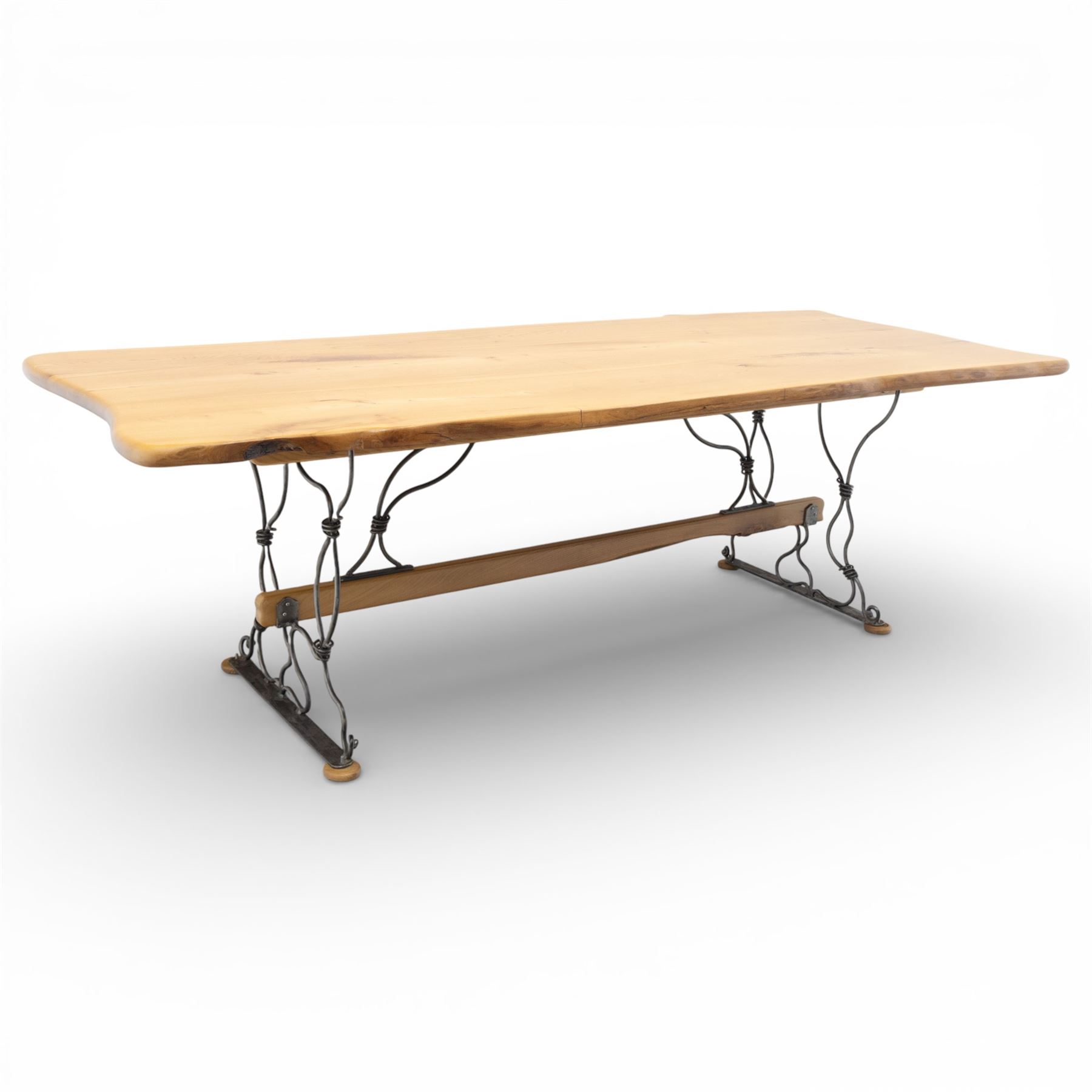 Paul Hodgkiss Designs of Glasgow - contemporary shaped elm dining table with wrought iron base; with set ten (8+2) matching high-back dining chairs, table of organic form above an elaborate wrought iron supports, with central elm stretcher, the chairs with en suite with matching wrought iron work burred elm headrest, purple velour upholstery with drop in seat     

Table: W 102cm, L 243cm, H 74cm
Chairs: W 56cm, D 52cm, H 130cm