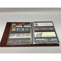 Royal Mail stamps including Queen Elizabeth II mint decimal presentation packs, special stamp year books etc, face value of usable postage approximately 500 GBP and a five pound coin cover, housed in four ring binder folders and loose