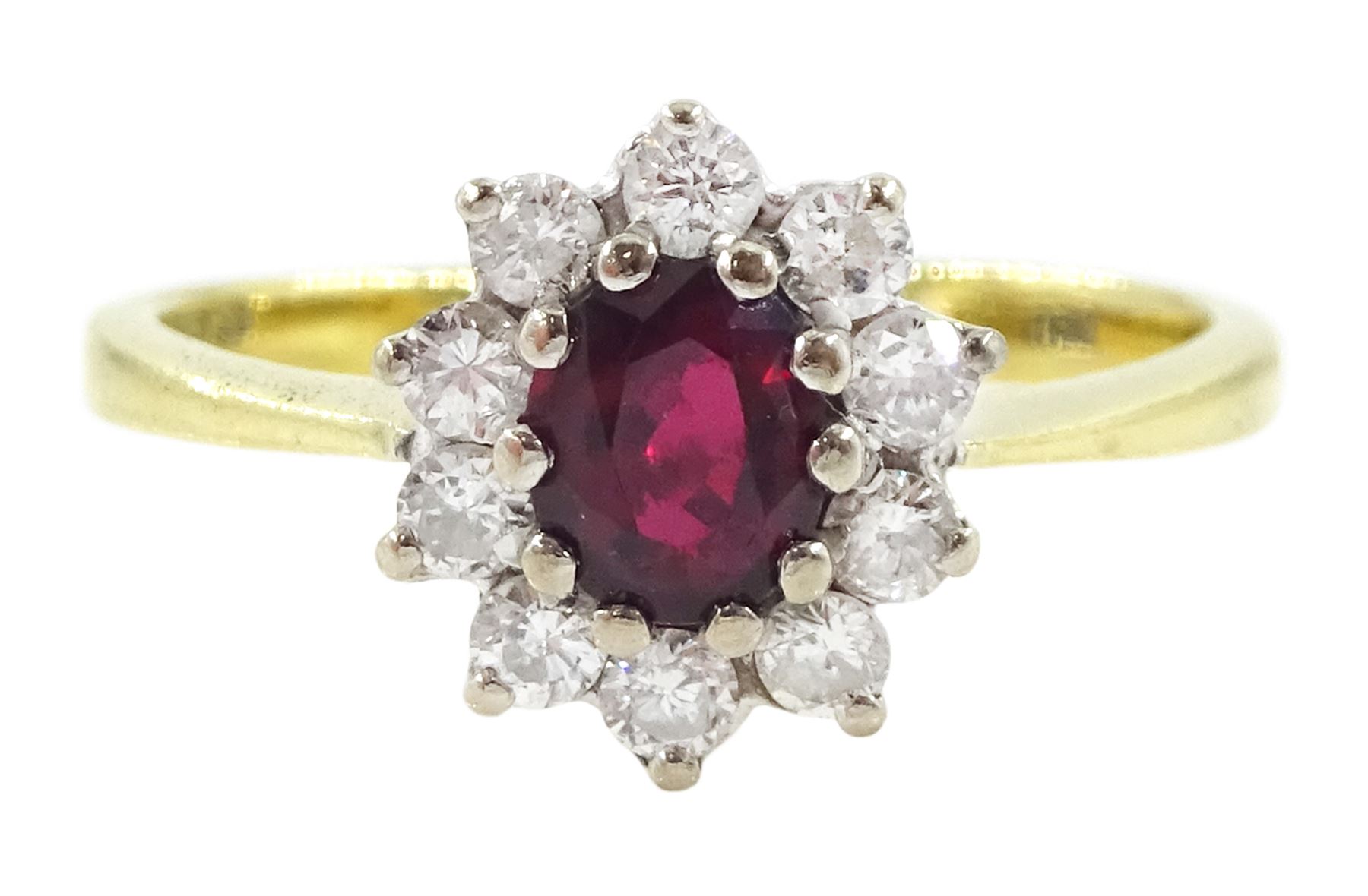 18ct gold oval cut ruby and round brilliant cut diamond cluster ring, London 1976, ruby approx 0.45 carat, total diamond weight approx 0.30 carat