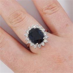 18ct white gold sapphire and diamond cluster ring, single oval cut sapphire of 4.33 carat, with round brilliant cut diamond surround, stamped 750, total diamond weight 0.72 carat