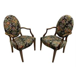 Pair of George III mahogany framed open armchairs, oval back and serpentine seat upholstered in fruit and foliage patterned fabric, shaped and moulded arms and arm supports, on square tapering moulded front supports 