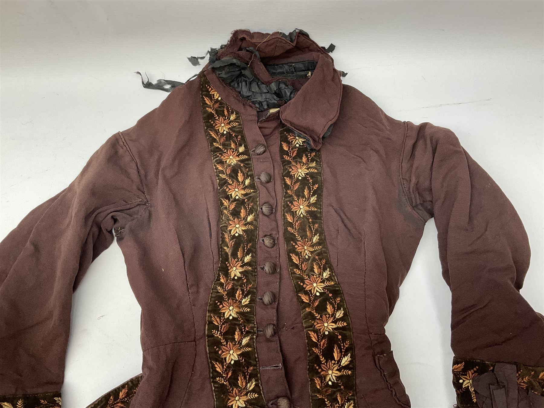 Victorian ladies riding habit, the two-piece construction in brown with embroidered floral velvet edging
