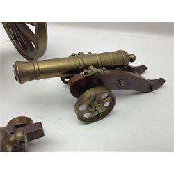 Large model brass cannon, upon wooden base, together with two similar smaller cannons, largest L48cm