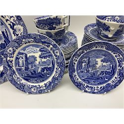 Spode blue and white Italian pattern dinner and tea wares, comprising five dinner plates, four side plates, seventeen side plates, four bowls, ten tea cups and twenty one saucers, five coffee cans and six saucers, and a flan dish, with blue and black printed marks beneath 