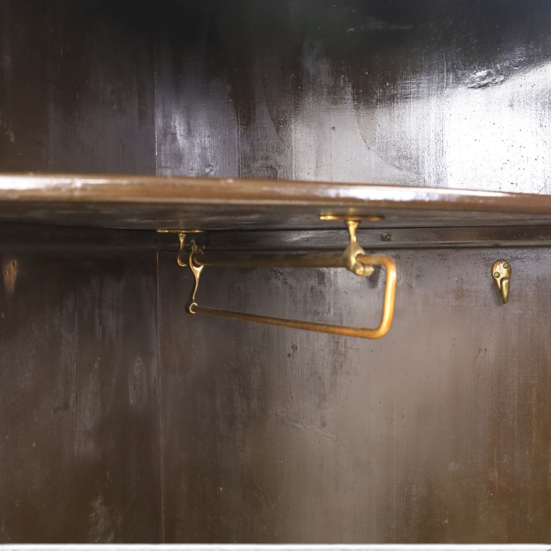 Edwardian inlaid mahogany cylindrical corner hall-robe, projecting cornice, figured veneer and crossbanded door, enclosing hanging hooks and shelf, raised on a plinth base with bracket feet