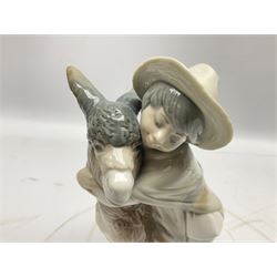 Seven Lladro figures, comprising Playful Puppy no 9135, Platero and Marcelino/Boy Hugging Donkey no 1181, Mini Seal Family no 5318, Attentive Polar Bear no 1207, Seated Polar Bear no1209, Eskimo Boy with Pet no 5238 and Girl with Geese no 1035, together with Nao goose