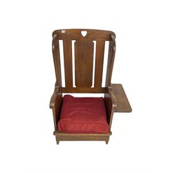 Arts and Crafts design oak reading wingback armchair, high back with pierced heart design, drop-leaf side table to one arm