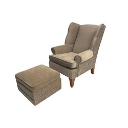 Georgian design wingback armchair, upholstered in beige fabric, raised on tapered supports, with matching footstool