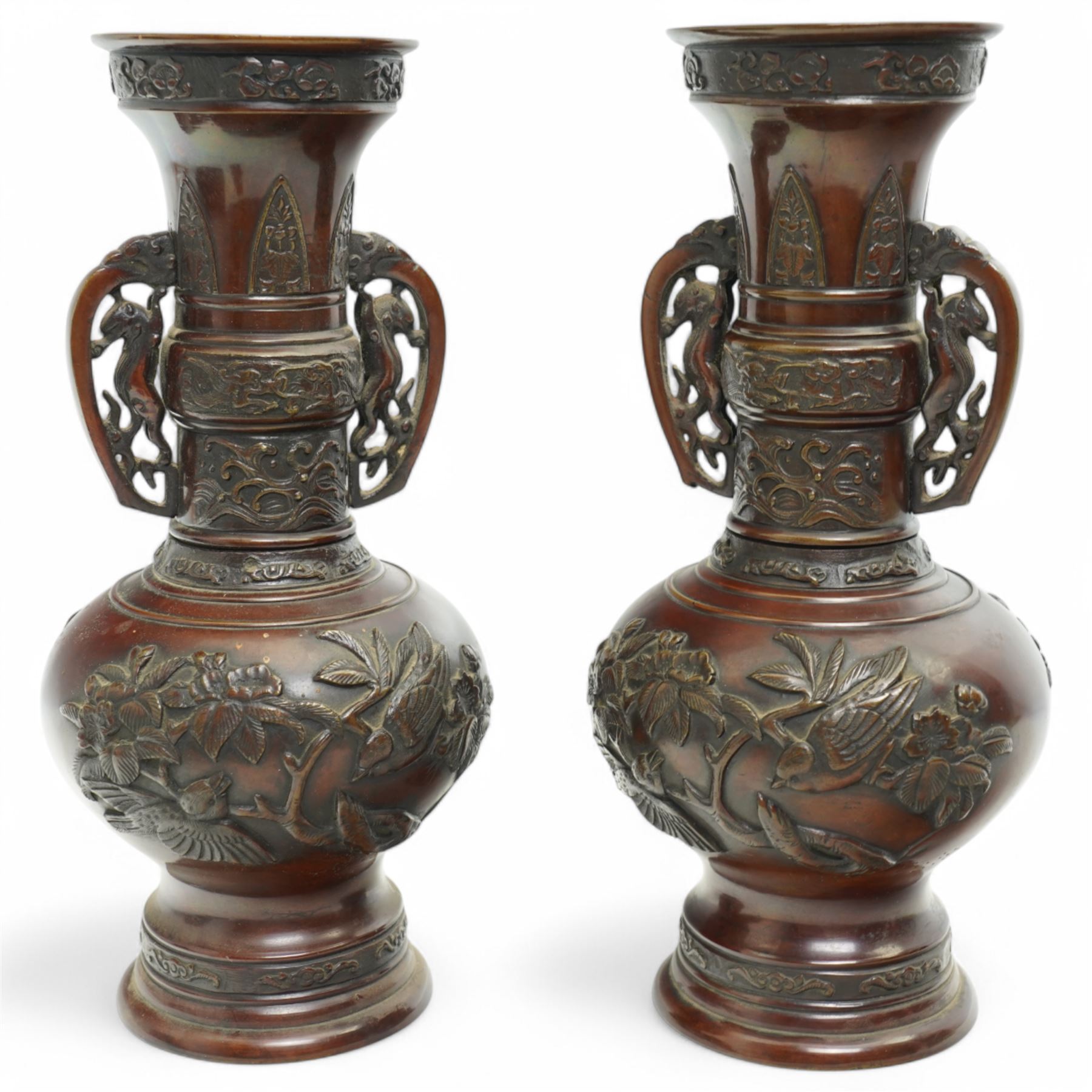 Pair of Japanese two-handled bronze vases, of baluster form with elongated neck, decorated with a raised pattern of birds and flowers, H26cm (2)