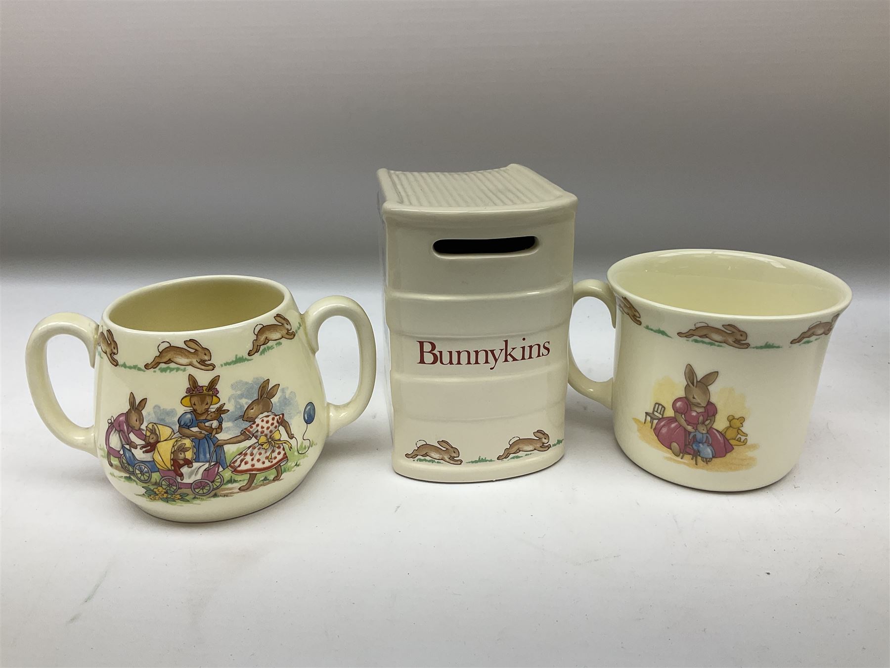 Royal Doulton Bunnykins ceramics, comprising two baby bowls, twin handled cup, two plates, money box, cup, bowl and spoon (9)