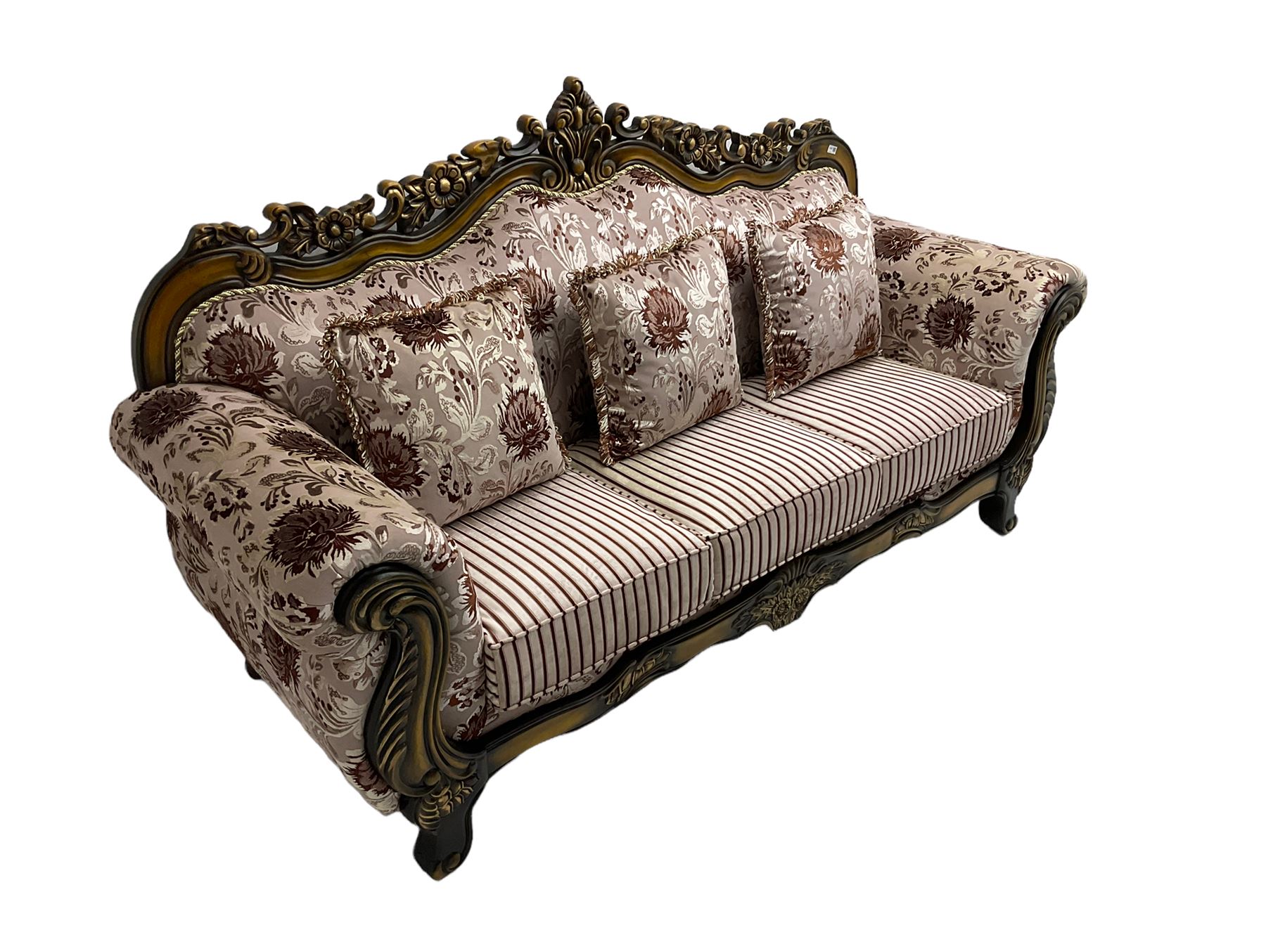 Italian Baroque design three seat sofa, hardwood framed, the cresting rail carved and pierced with c-scrolls and flower heads, scrolled arms, upholstered in floral patterned and striped fabric, with scatter cushions 