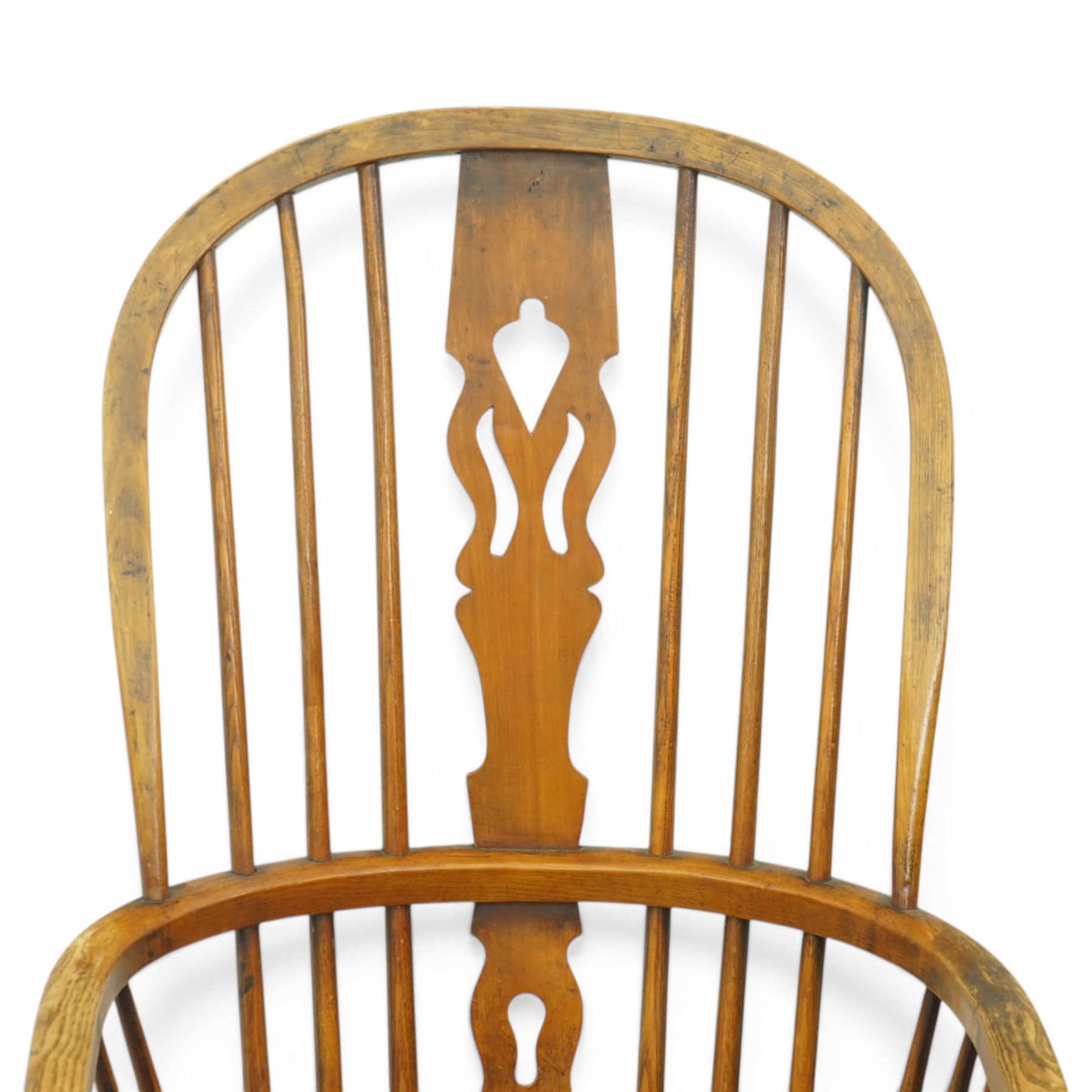 Set of two late 19th century elm and beech Windsor armchairs, each with hoop backs and turned spindles, shaped central splats, solid seats and turned supports united by H-stretchers