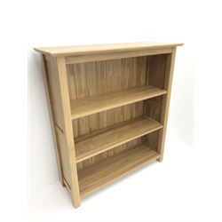 Light oak open bookcase,  two shelves, stile supports