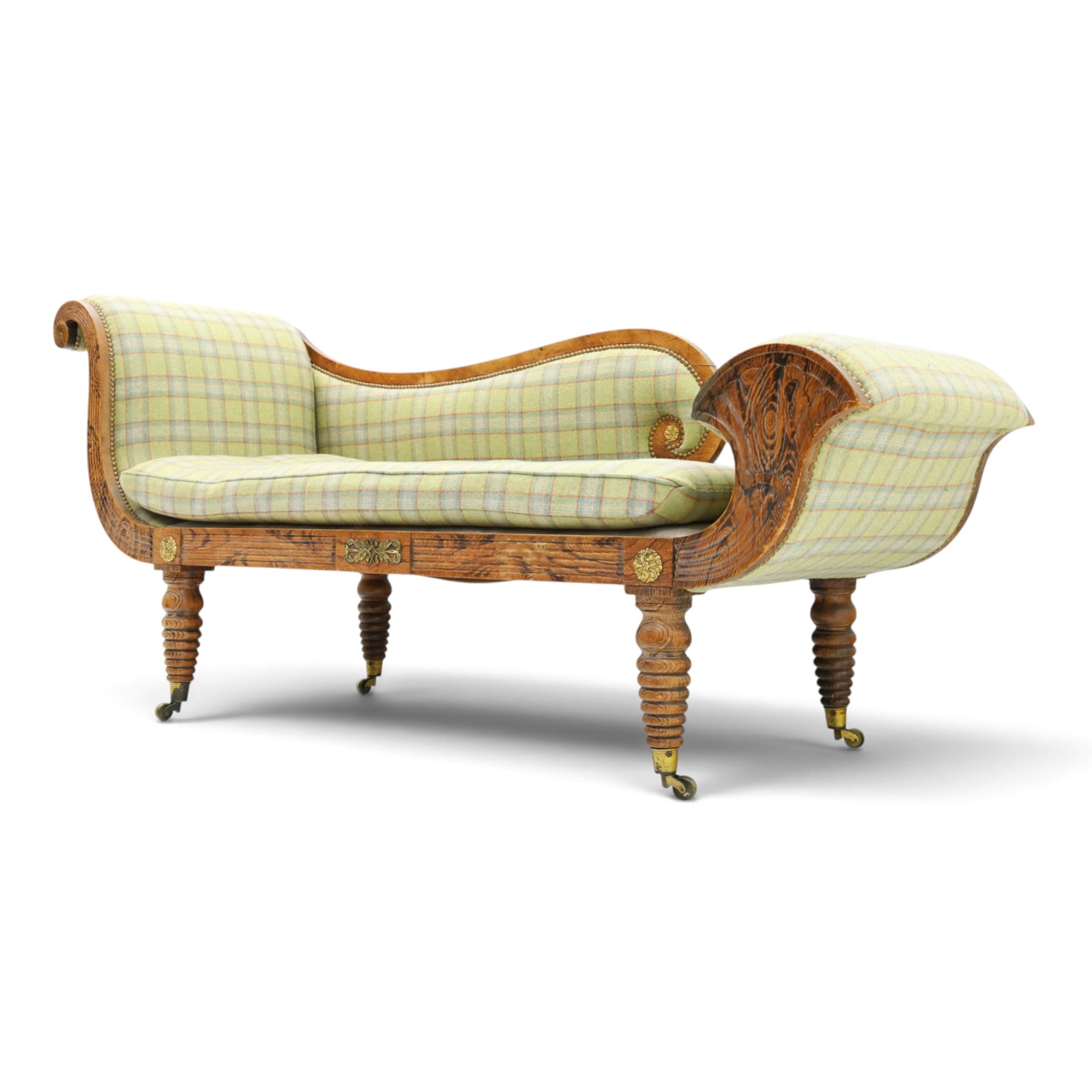  19th century scumbled oak chaise longue upholstered in tartan fabric, swept frame with gilt mounts, studded border with loose base cushion, raised on turned bobbin supports terminating brass castors